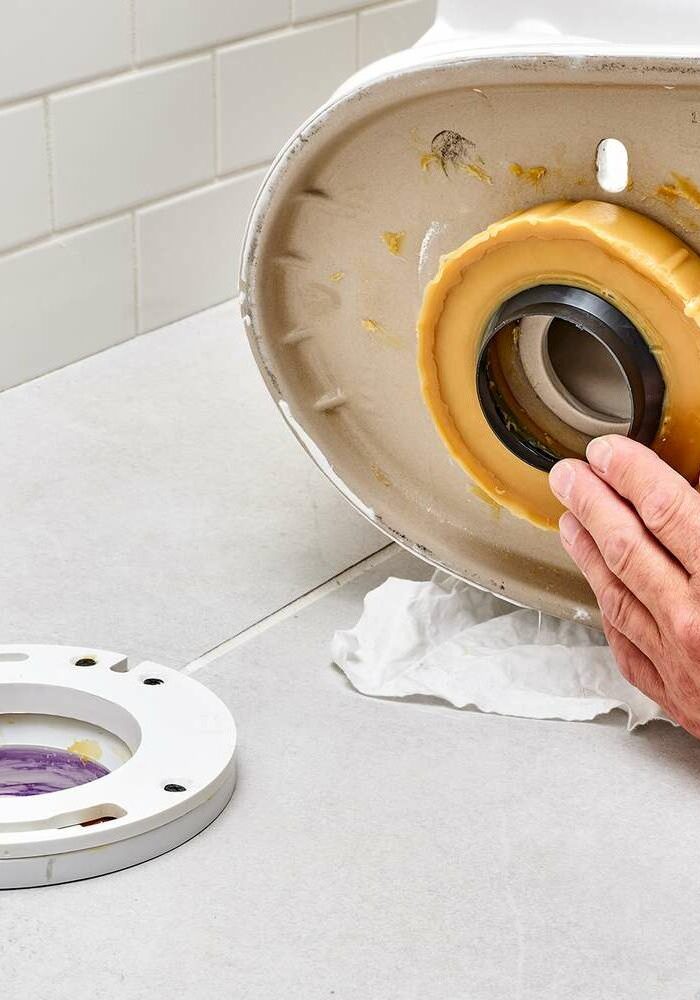 Plumber-Installing-a-New-Flange-Extension