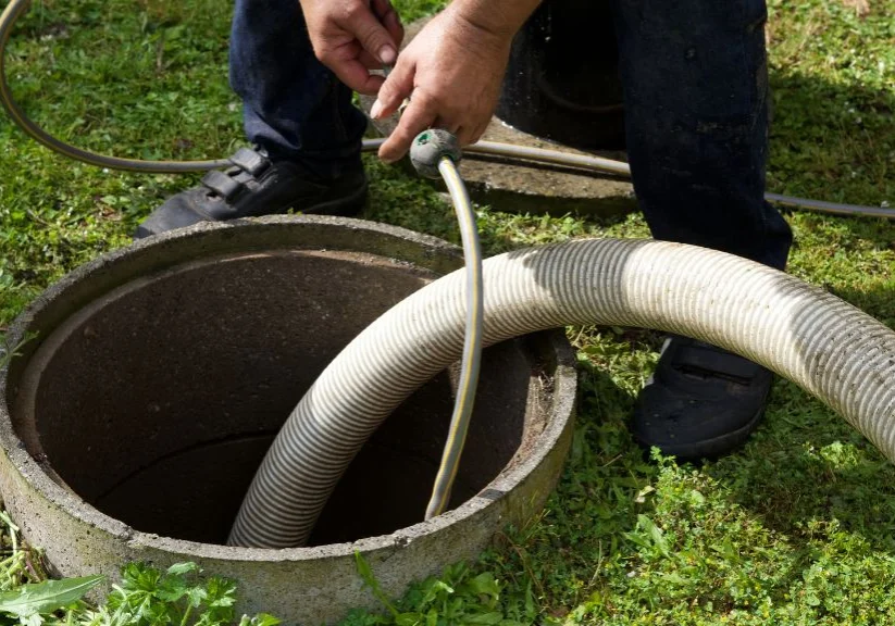 Plumber-Cleaning-a-Residential-Septic-Tank